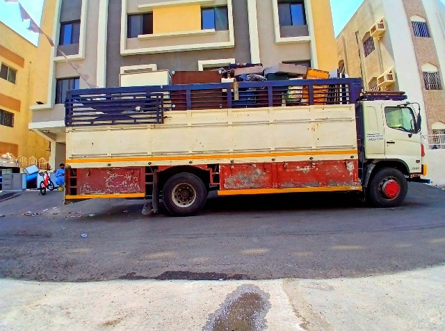 Professional moving team with modern equipment and trucks